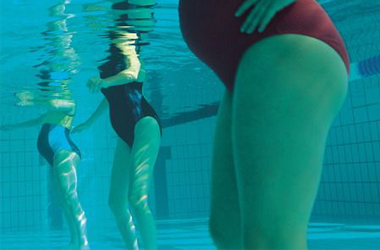exercise class held in a swimming pool