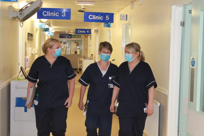 Specialist nurses walking along hospital corridor