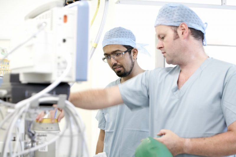 Two theatre staff checking equipment