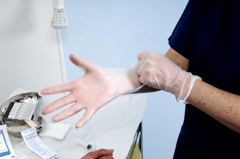 Staff putting gloves surgical gloves