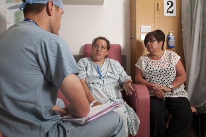 Anaesthetist discussing procedure with maternity patient and their relative