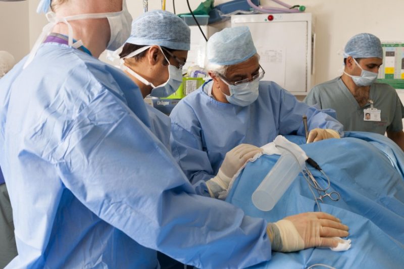 Doctors in surgical theatre doing surgery