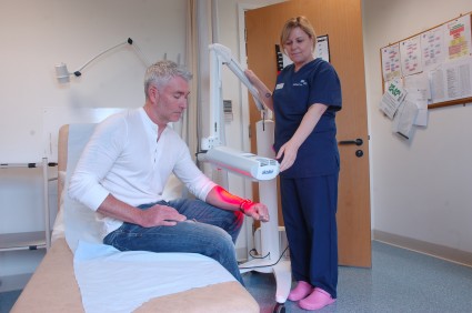 Specialist skin service patient in treatment room.