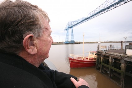 Man with hearing aid looking our past Teesside's Transporter Bridge