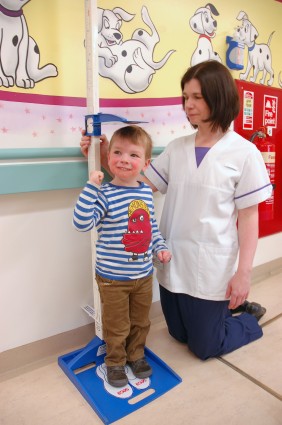 Dietitian measuring the height of a child.
