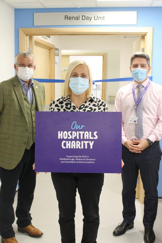 Renal patient Sarah Eales holds up an Our Hospitals Charity sign during the official opening of the new look renal day unit alongside fellow patient Neal Waters and head of charity Ben Murphy.