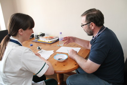 Patient and therapist sat at dining room table