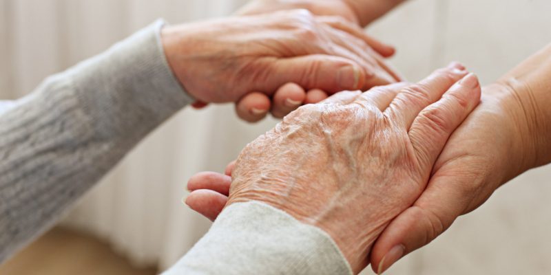 Hands helping in supporting a patient