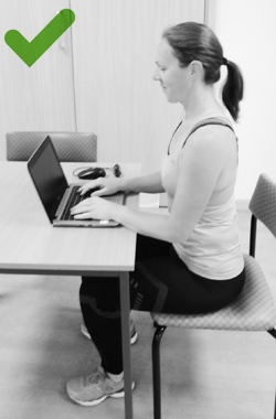 Sitting with back supported and laptop on the table top