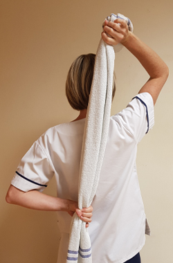 hands holding a towel drying the back