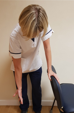 Holding chair for support, affected arm with the palm outwards