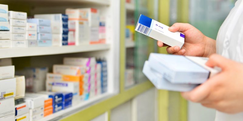 Image showing medication stacked on shelving in a pharmacy environment