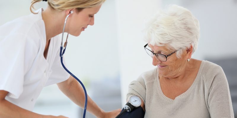 Image of a nurse taking a patients blood pressure.