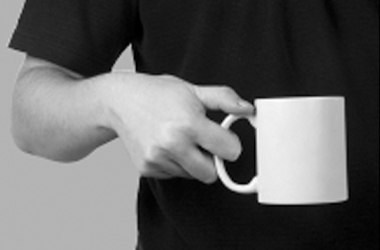 holding a cup in one hand