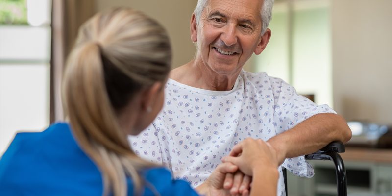 A volunteer offering a helping hand to a patient.