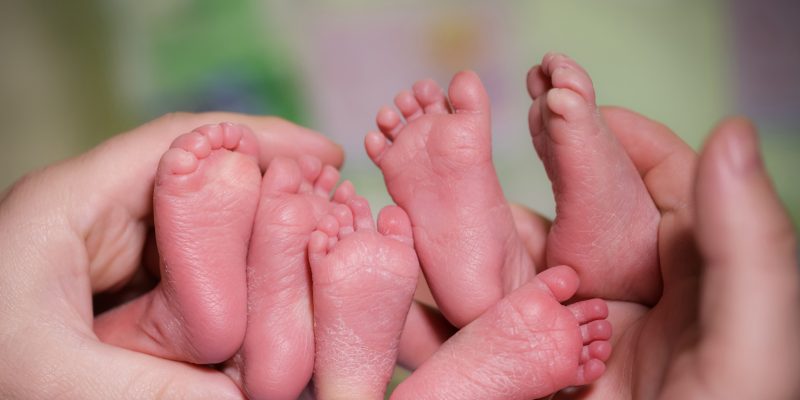 Close up of the bottom of 3 triplets feet 