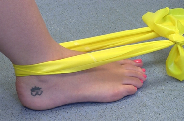 Closeup of resistance band around the ankle