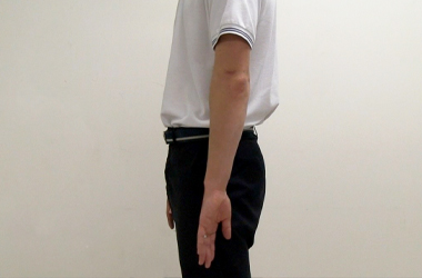 Back of your thumb is placed against side of body