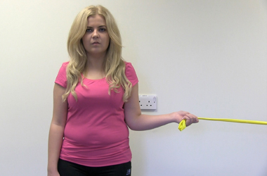 Pulling the resistance band across the stomach