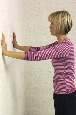 Hands at shoulder level, and shoulder width apart on the wall