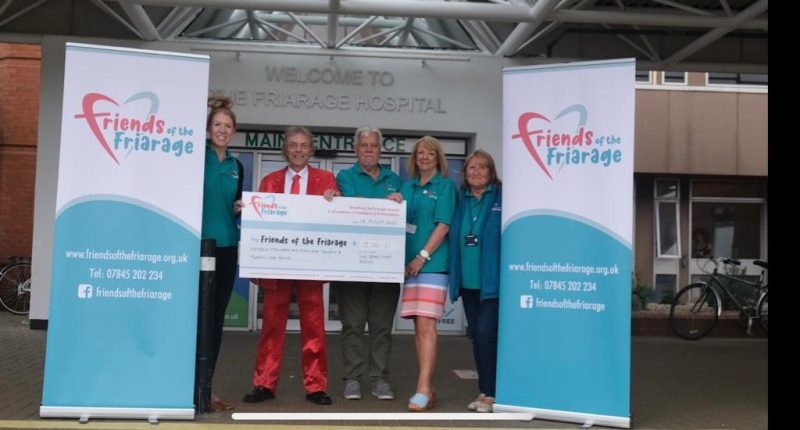 Barn That Rocks cheque presentation outside Friarage Hospital main entrance