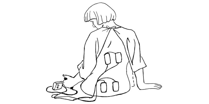 A line drawing of a lady sat down, using a TENS machine