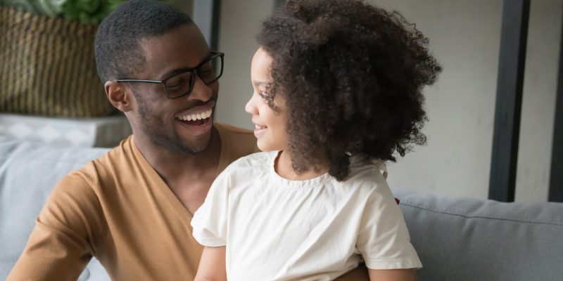 Dad smiling with his daughter