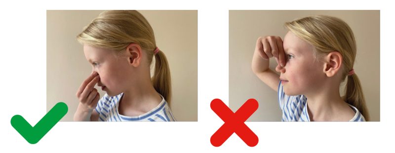 young person holding their nose head tilting forwards - a tick is on this image. To the right the image shows the head in an upright position and nose pinched on the bridge - a red cross is on this image indicating the wrong way to do this.