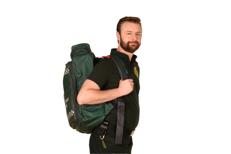 A paramedic carrying an equipment bag 