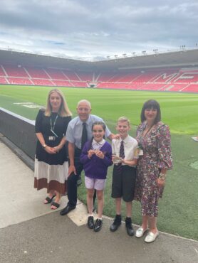 Dave along with pupils and staff