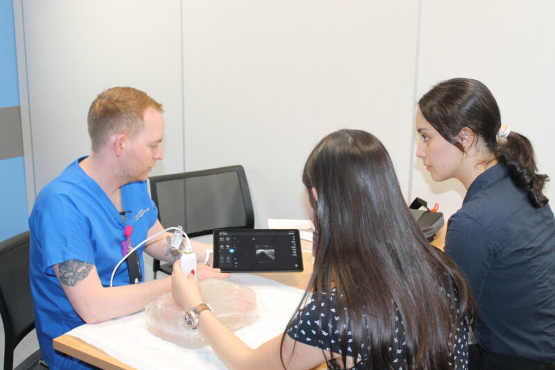 Two students participating in an interactive radiology session