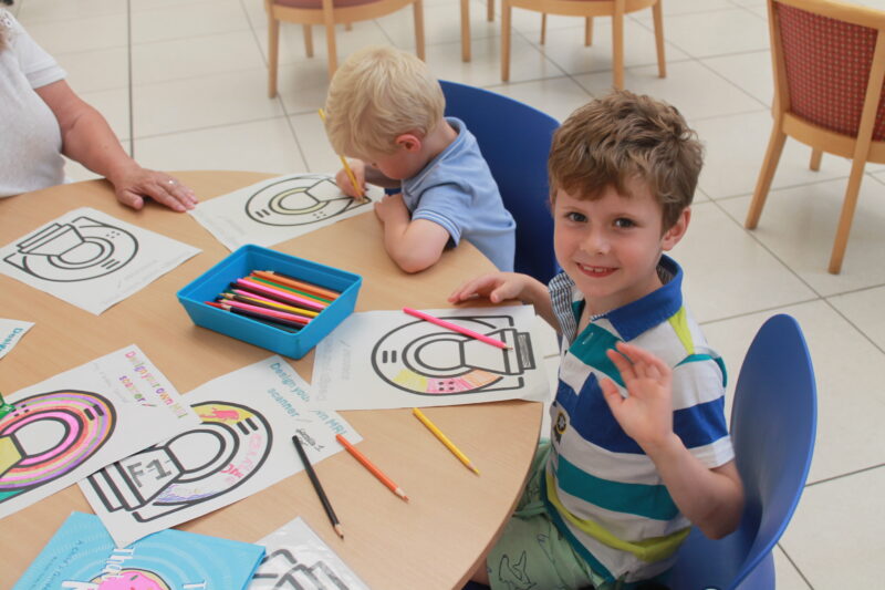 Charlie Gordon,6, waving his hand with his brother Frankie Gordon,3