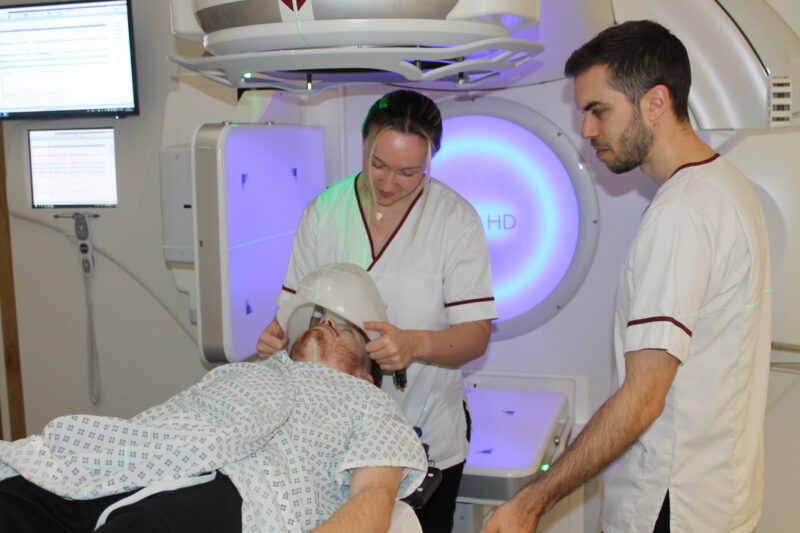 Radiotherapy team treating a patient
