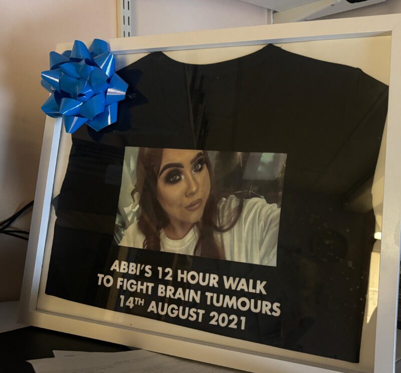 Photo frame of Abbi's fundraising achievement in Mr Varma's office