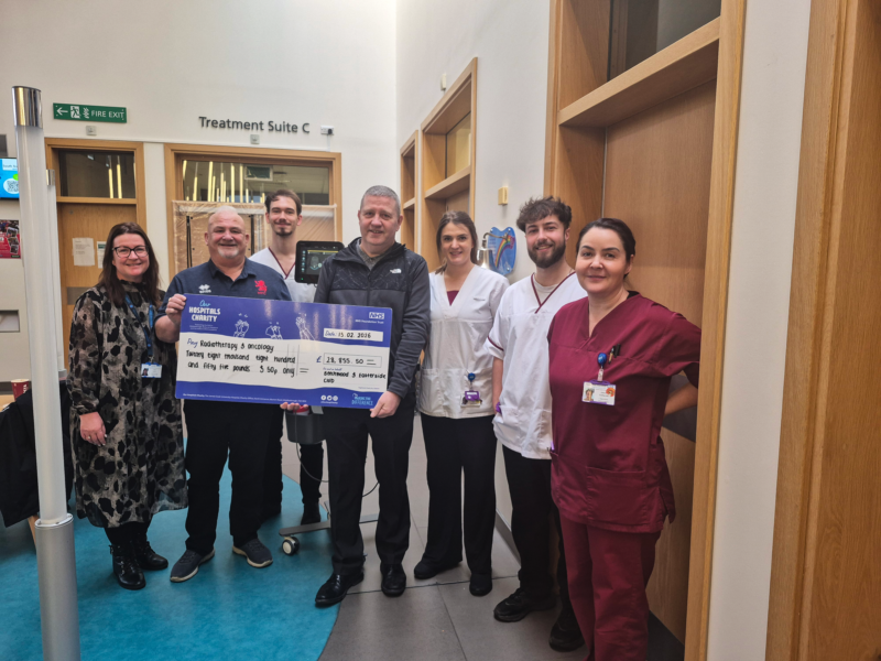 Mick and Harry present the cheque to staff at The James Cook University Hospital