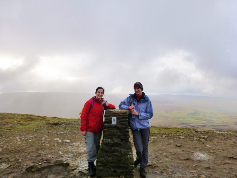 Two people at the top of the three peaks challenge