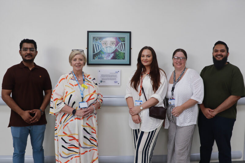 Chief executive Stacey Hunter and some of the respiratory team in fron of the new art installation.