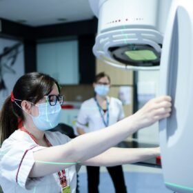Staff with radiotherapy machine