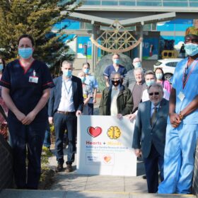Clinical staff outside hospital entrance