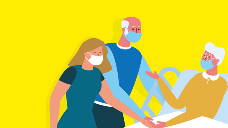 Two visitors with a patient in hospital