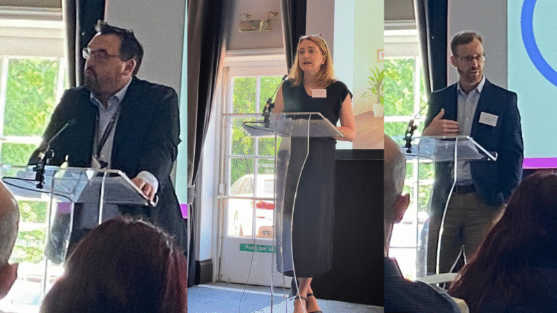 Three speakers in front of the microphone