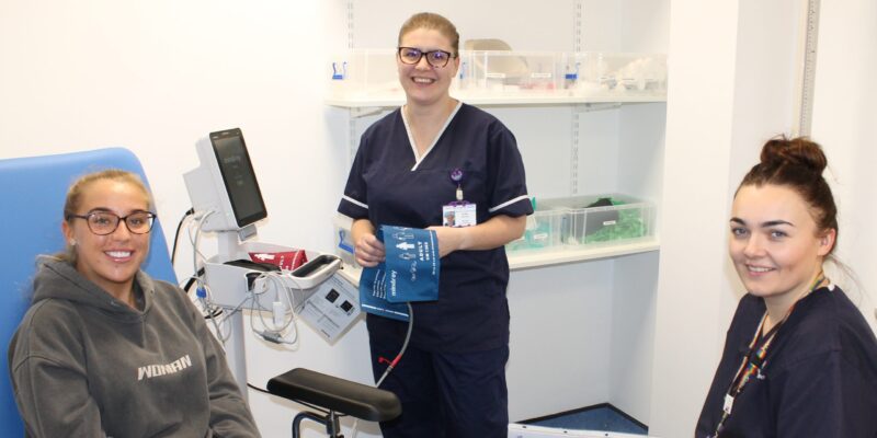 Two research nurses conducting a preassessment on a young female patient