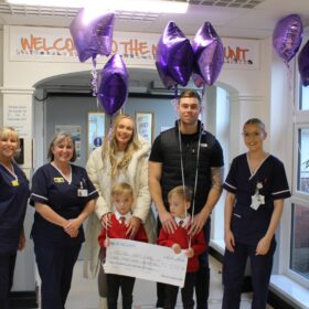 The-Adams-handing-over-the-cheque