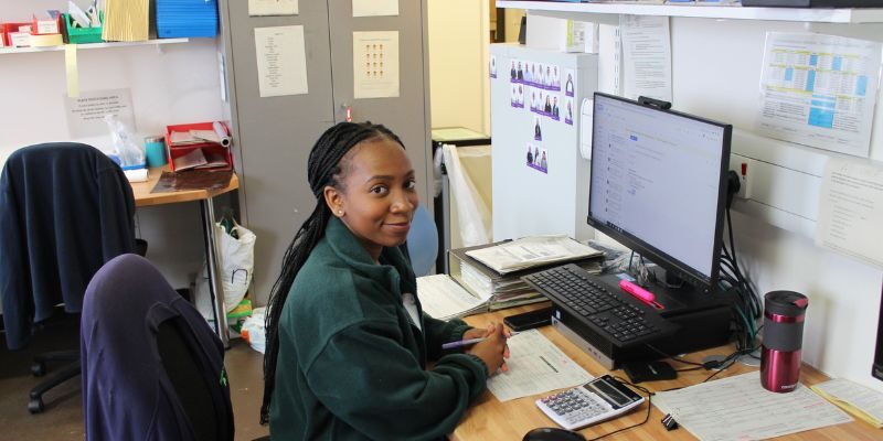 Charity sat at her desk