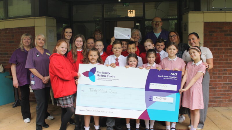 School pupils presenting the cheque