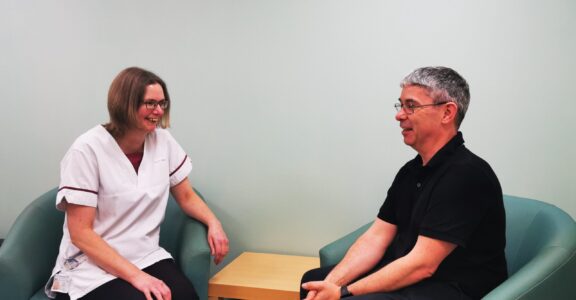 Review team member speaking to patient