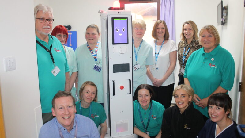 James Dunbar with the robot and representatives from Friends of the Friarage, Akara and the Friarage team