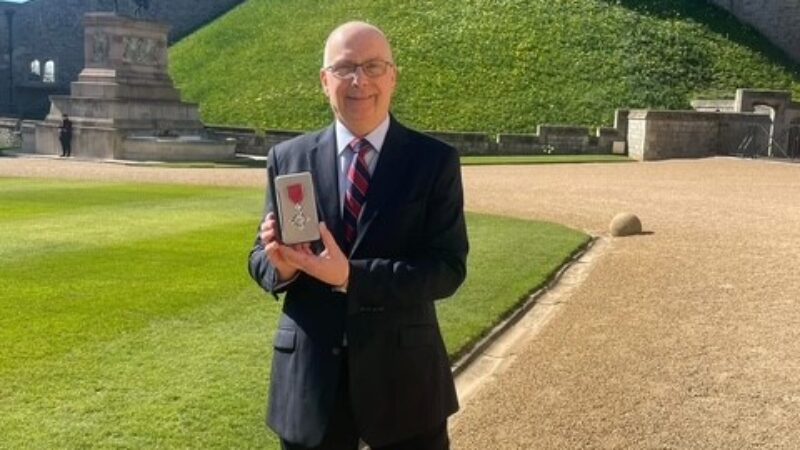 Professor Nick Linker with his MBE outside Windsor Castle