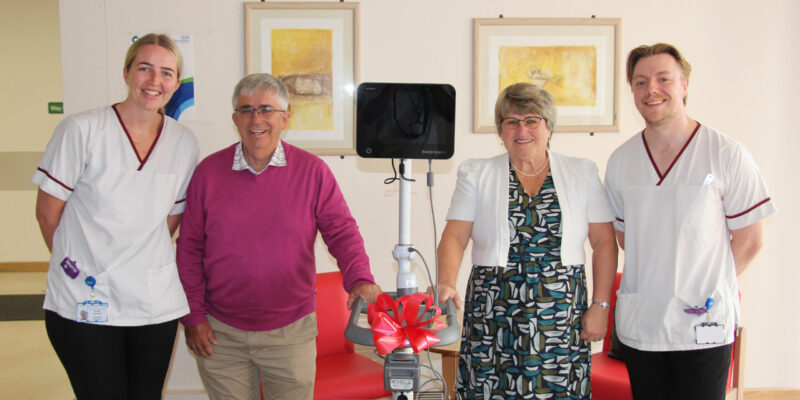 A group of people with a bladder scanner machine