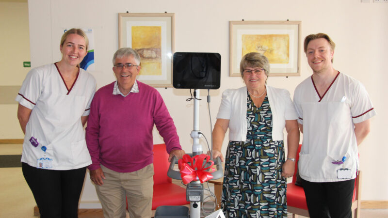 A group of people with a bladder scanner machine